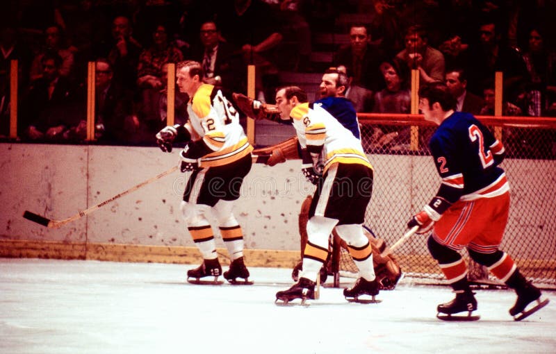 Boston Bruins forwards Wayne Cashman (12) and Ken Hodge (8) battle the New York Rangers goalie Ed Giacomin and defenseman Brad Park (2). Image taken from color slide. Boston Bruins forwards Wayne Cashman (12) and Ken Hodge (8) battle the New York Rangers goalie Ed Giacomin and defenseman Brad Park (2). Image taken from color slide.