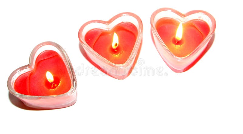 Drie rode hartvormige kaarsen stock afbeelding