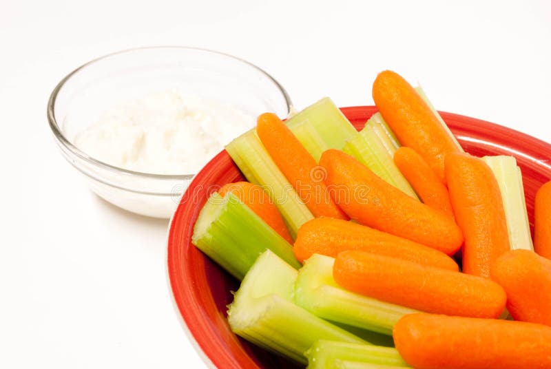 Bowl of baby carrots and celery, with dip. Bowl of baby carrots and celery, with dip.