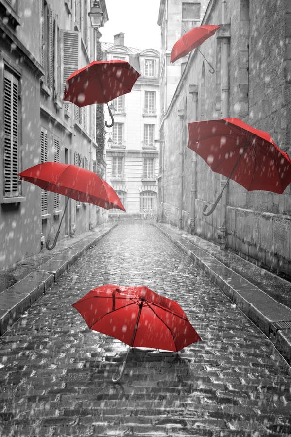 Rode paraplu's die op de straat vliegen Conceptueel beeld