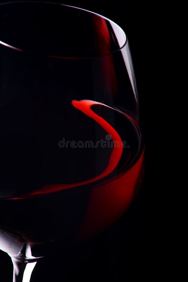 Red wine glass in black background. Red wine glass in black background