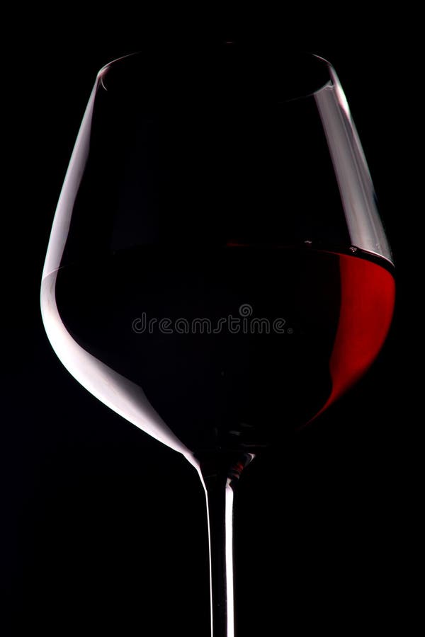 Red wine glass in black background. Red wine glass in black background