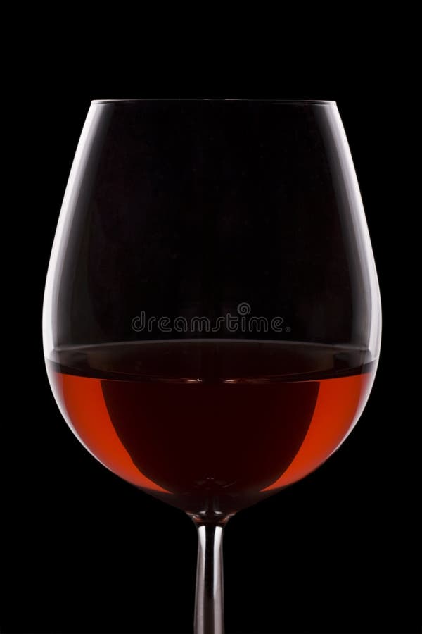 Isolated red wine glass over a black background. Isolated red wine glass over a black background