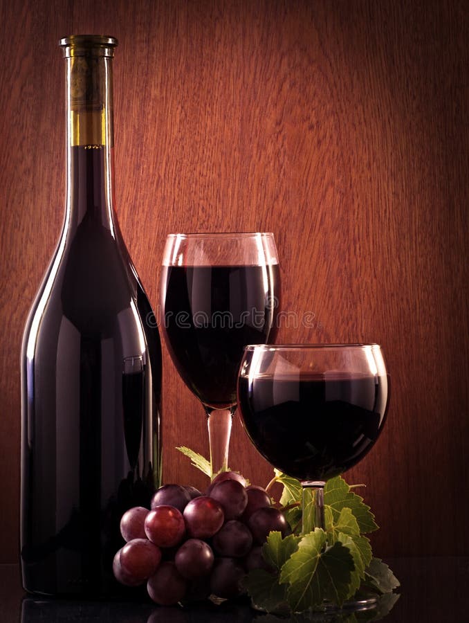 Red wine glass and Bottle on a wooden background. Red wine glass and Bottle on a wooden background.