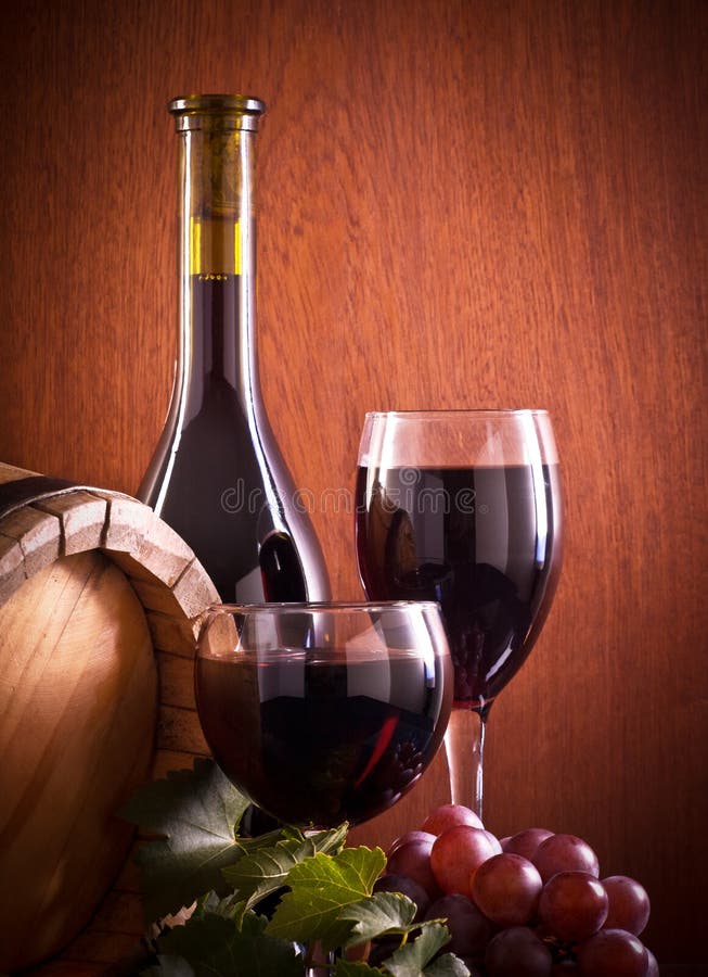 Red wine glass and Bottle on a wooden background. Red wine glass and Bottle on a wooden background.