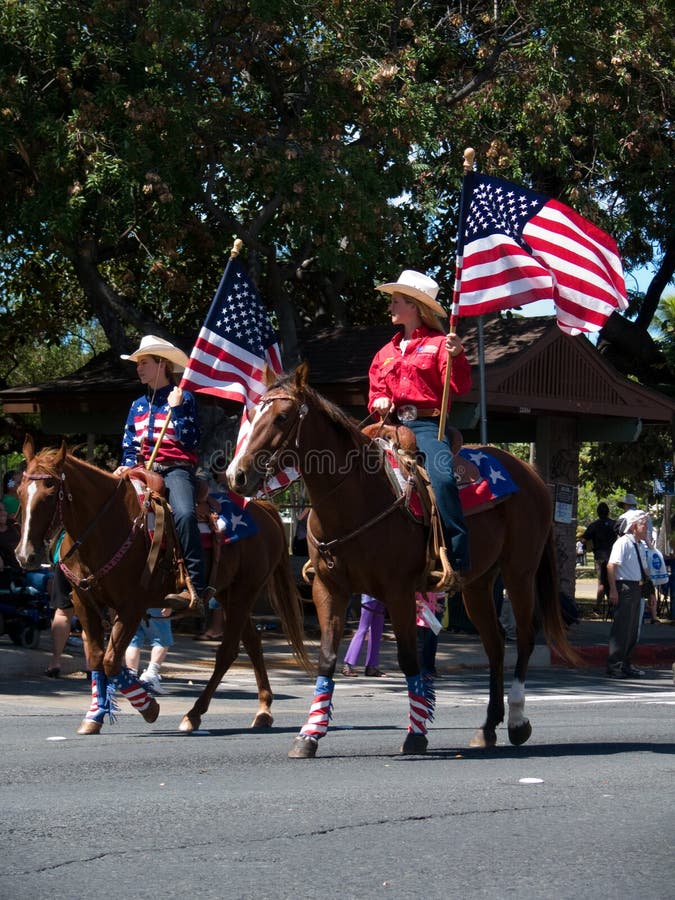 Event: 2010 Aloha Festival Parade, 25.IX.10 Location: Honolulu, O'ahu, Hawai'i, USA Subject: Rodeo girls seldom miss an opportunity to fly the American flag, the home of their sport!