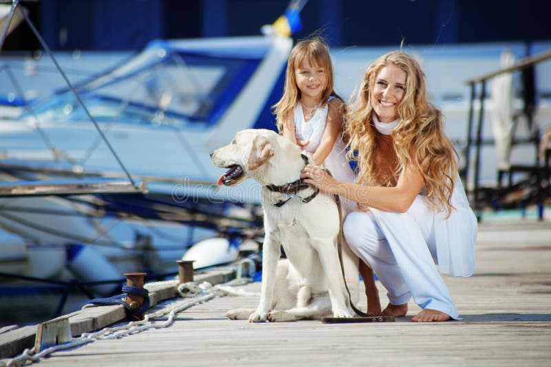 Happy family with dog on berth in summer. Happy family with dog on berth in summer