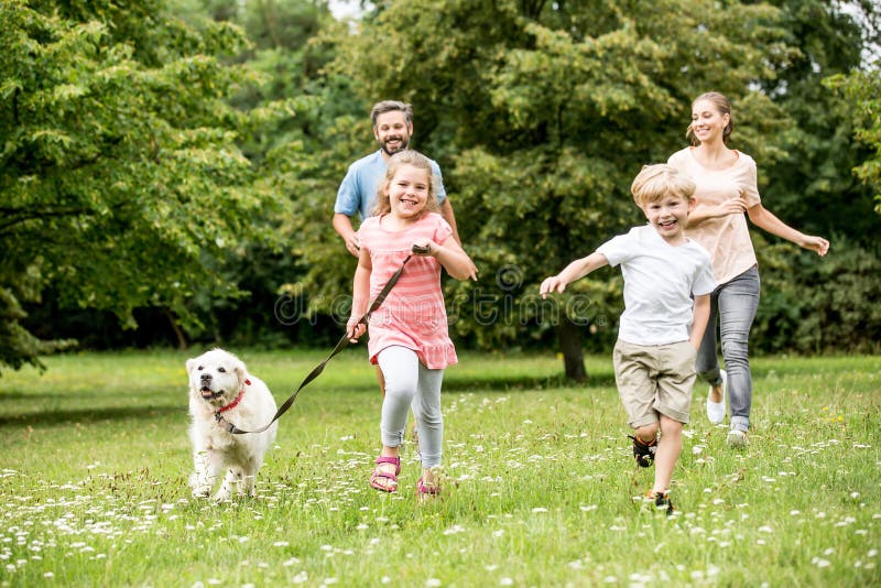 Happy family with two children and dog having fun in summer in the meadow. Happy family with two children and dog having fun in summer in the meadow