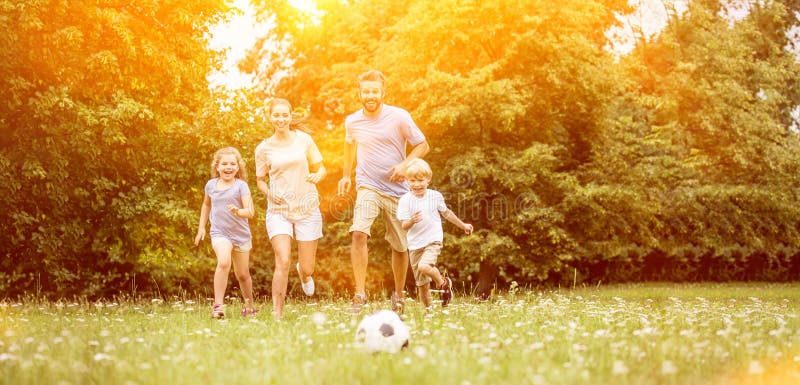 Family with soccer ball in summer playing and having fun. Family with soccer ball in summer playing and having fun