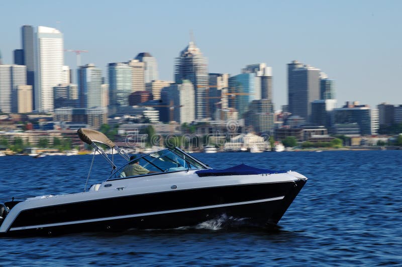 Tourist enjoying the view of Seattle city from speeding boat. Tourist enjoying the view of Seattle city from speeding boat