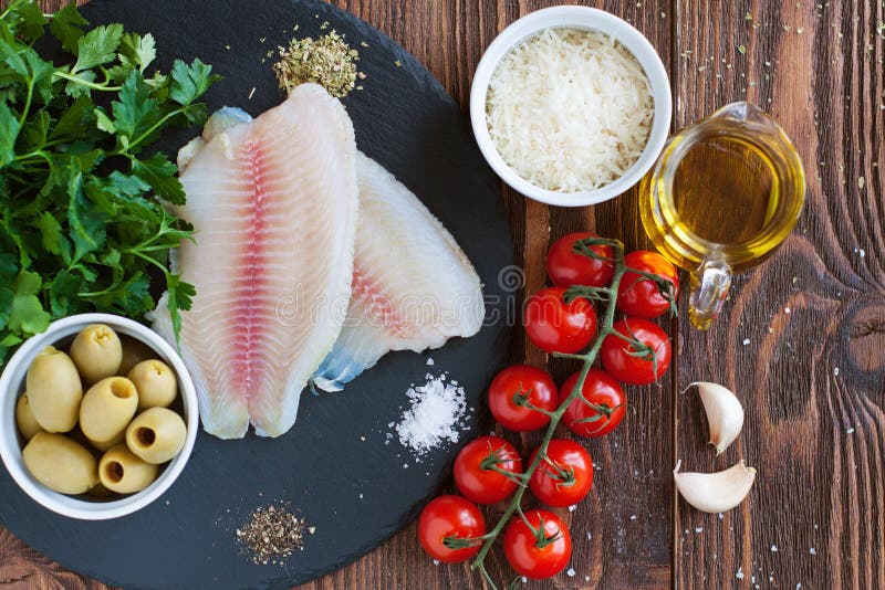 Roher Tilapia und Gemüse, Bestandteile für Mittelmeerart backten Fische stockfotos Roher Tilapia und Gemüse, Bestandteile für Mittelmeerart backten Fische stockfotos