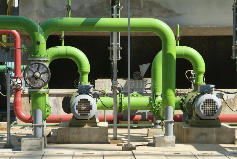 Pumps, valves and green steel pipes at industrial cooling tower. Pumps, valves and green steel pipes at industrial cooling tower.