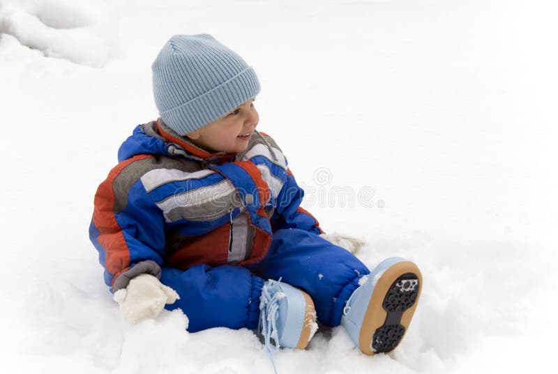 A little baby boy takes fun in the snow. A little baby boy takes fun in the snow