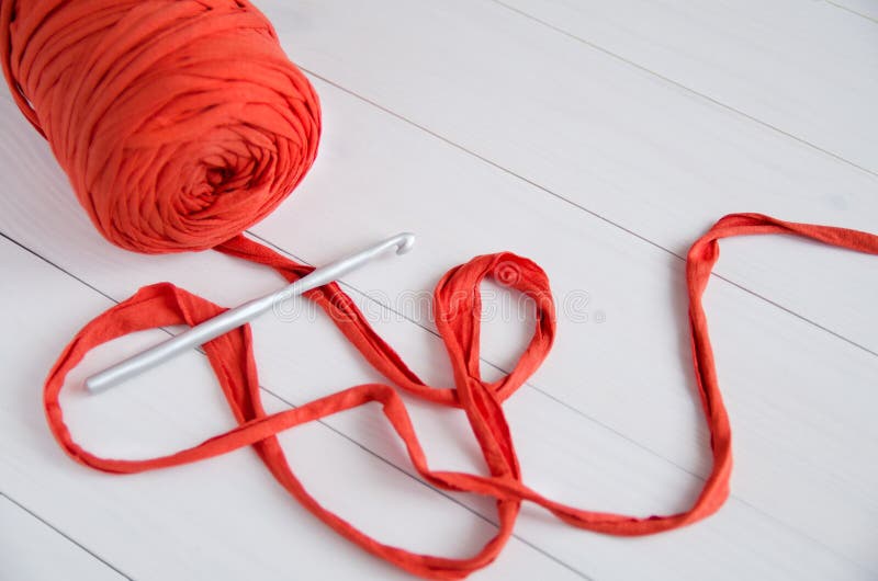 Roll the cotton yarn and crochet hook on white wooden background. The concept of crochet, hobby, needlework, self-realization stock photos Roll the cotton yarn and crochet hook on white wooden background. The concept of crochet, hobby, needlework, self-realization stock photos
