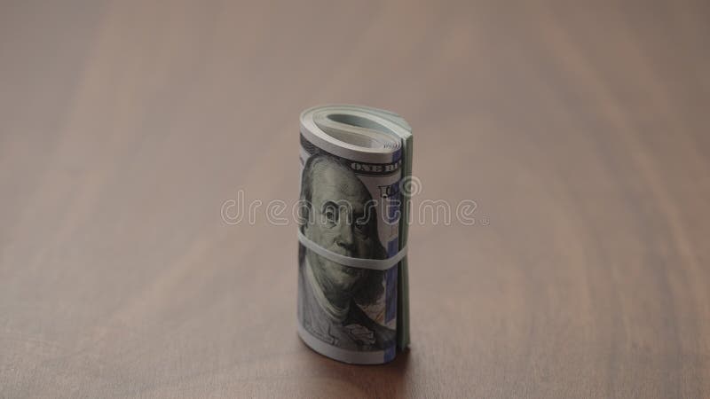 Roll of Hundred Dollar Bills on Walnut Table Slide Shot Stock Footage ...