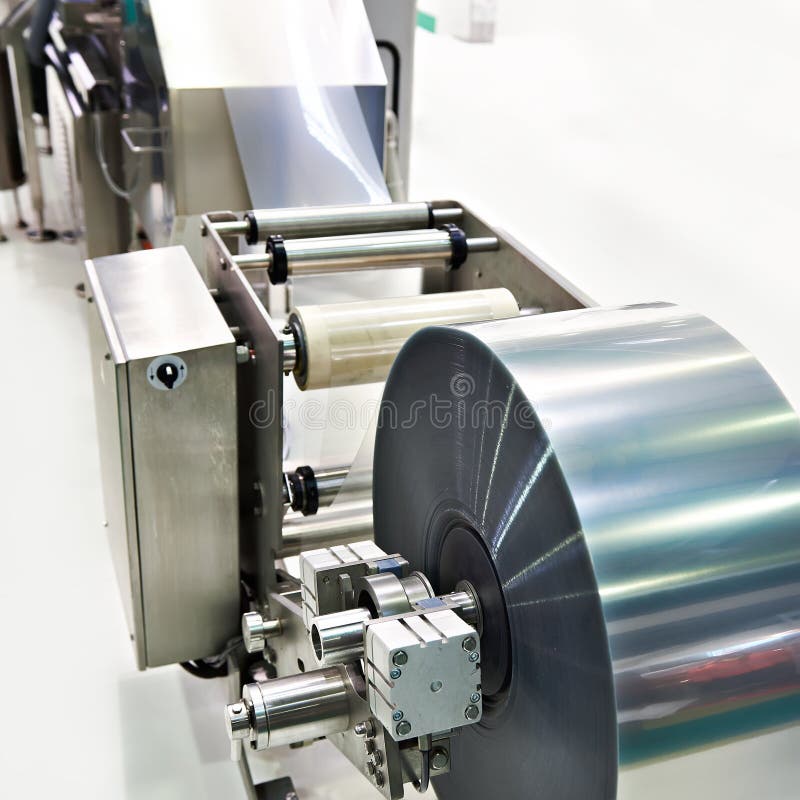 Roll of packaging film on machine food factory royalty free stock photography Roll of packaging film on machine food factory royalty free stock photography