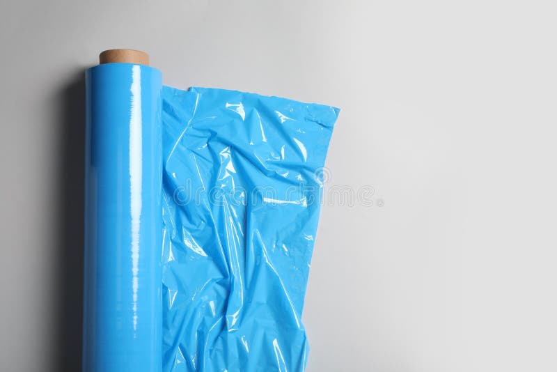 Roll of Plastic Stretch Wrap Film on White Background, Top View. Space