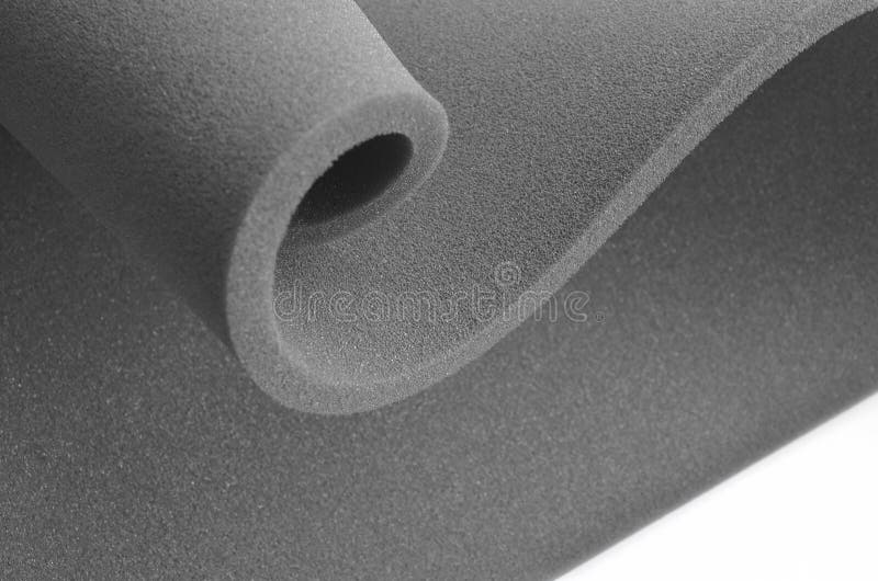 A heap of white shipping foam on black sheet of wavy foam rubber, Stock  image