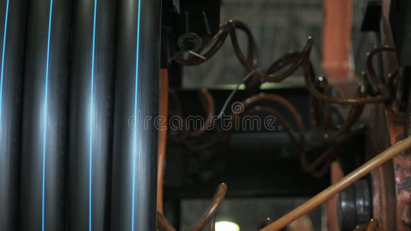 Roll threading coil pipe. Manufacture of plastic water pipes factory. Process of making plastic tubes on the machine stock image