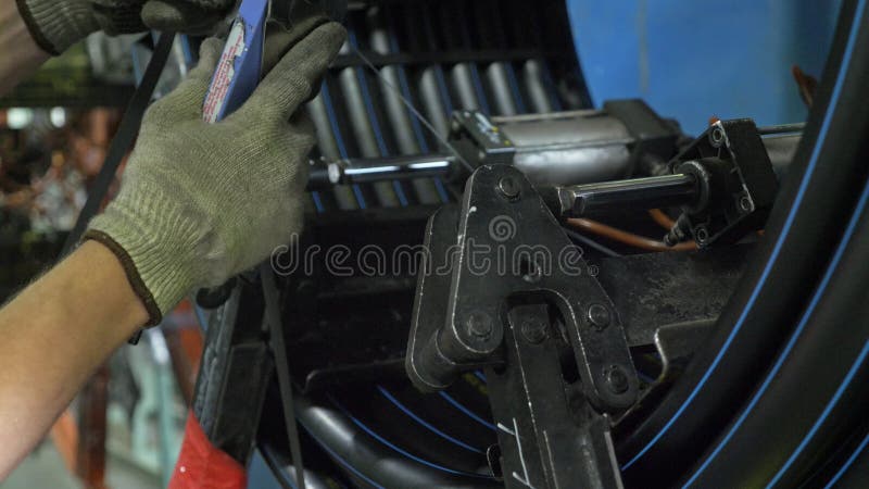 Roll threading coil pipe. Manufacture of plastic water pipes factory. Process of making plastic tubes on the machine stock photos