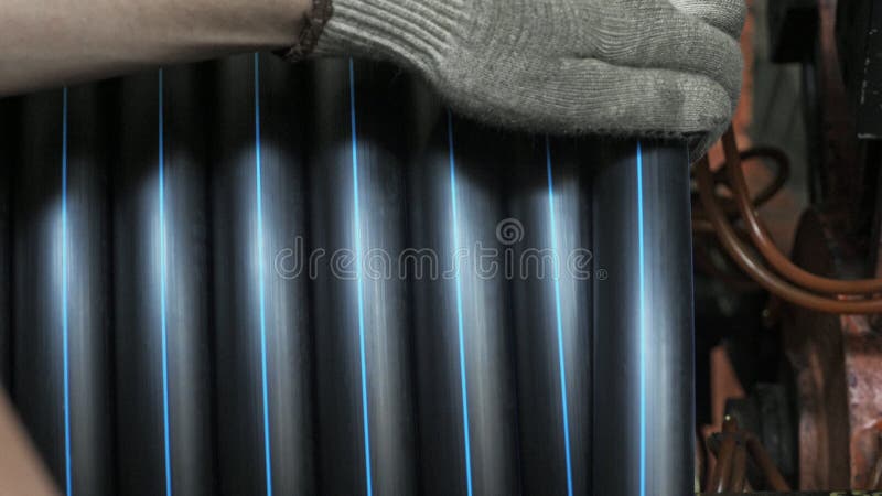 Roll threading coil pipe. Manufacture of plastic water pipes factory. Process of making plastic tubes on the machine royalty free stock photography