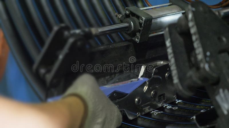 Roll threading coil pipe. Manufacture of plastic water pipes factory. Process of making plastic tubes on the machine stock image