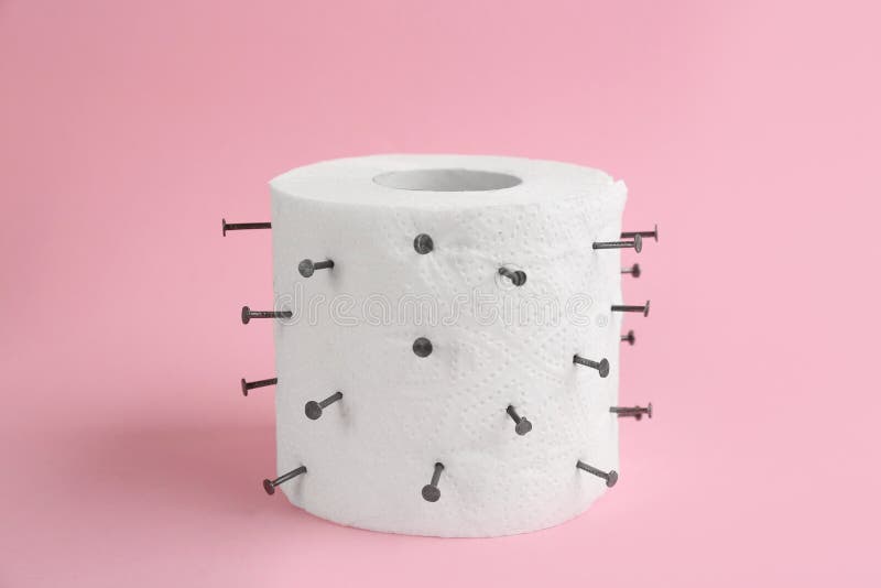 Roll of Toilet Paper with Nails. Hemorrhoid Problems Stock Image