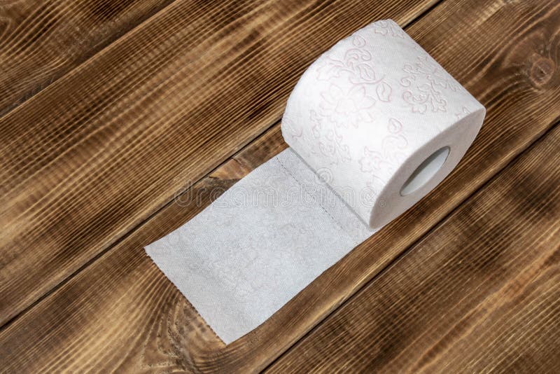 A Roll of Toilet Paper on a Wooden Table. Close Up Stock Image - Image ...