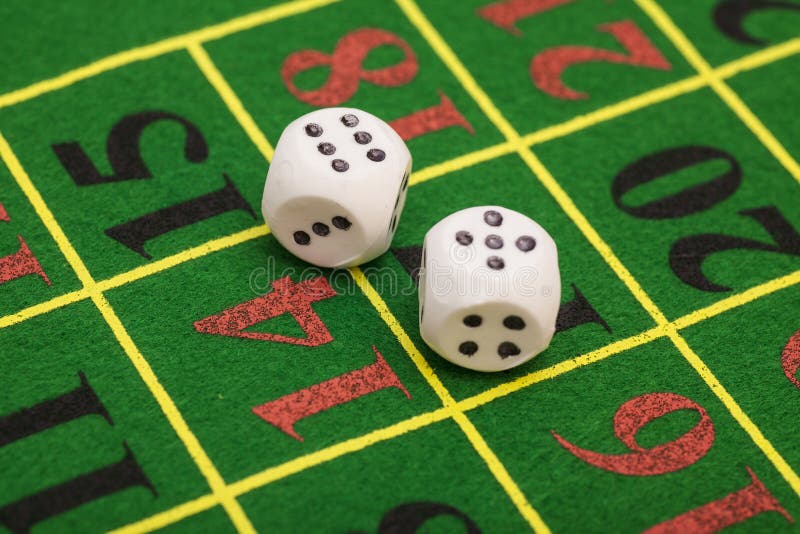 Roll of the white dice on game table in a casino stock photos Roll of the white dice on game table in a casino stock photos