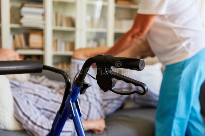 Rollator in the living room of senior with disability and physiotherapist in the background