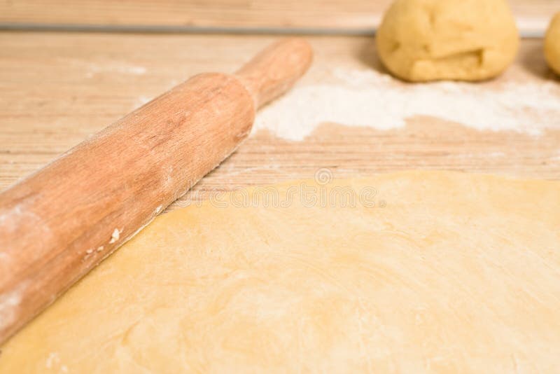 Rolled Dough with Butter on the Table with a Rolling Pin for Rolls and