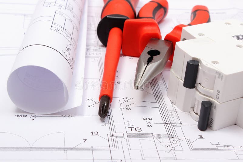 Rolled electrical diagrams, electric fuse and work tools on construction drawing of house stock photo