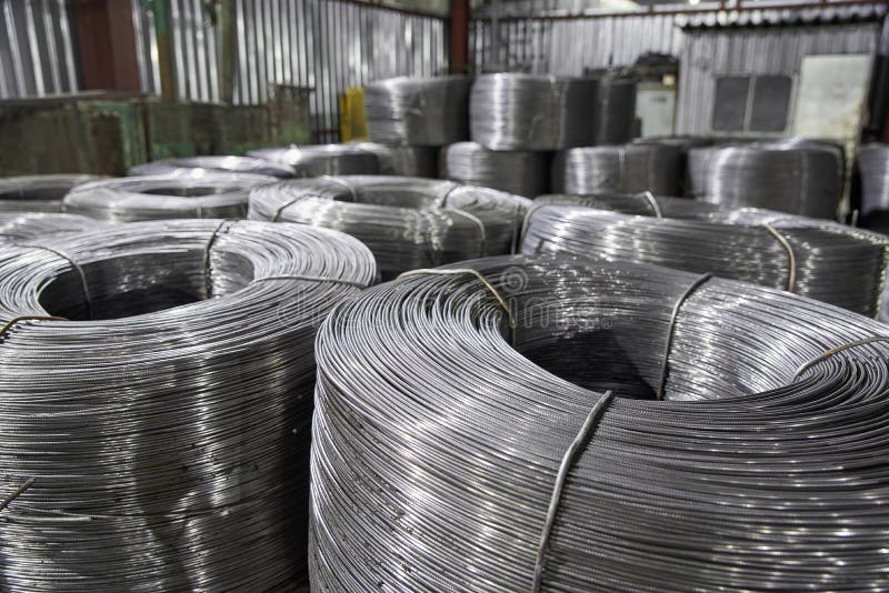 Rolled Metal Wire in Reels is Stored in a Warehouse in Packages Stock