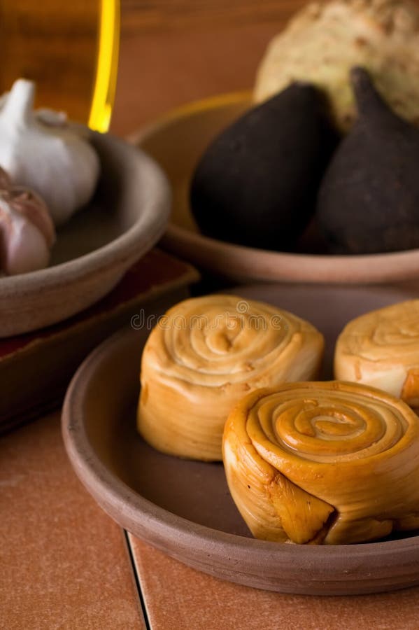 Rolled smoked cheese in earthen bowl stock images Rolled smoked cheese in earthen bowl stock images
