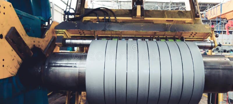 Rolled steel. Stack of rolls, cold rolled steel coils in action. Galvanized steel sheet and rusted edge. Cold rolled steel coils. Drum turns sheets into production. Industrial. Metal steel drum stock images, royalty-free photos and pictures