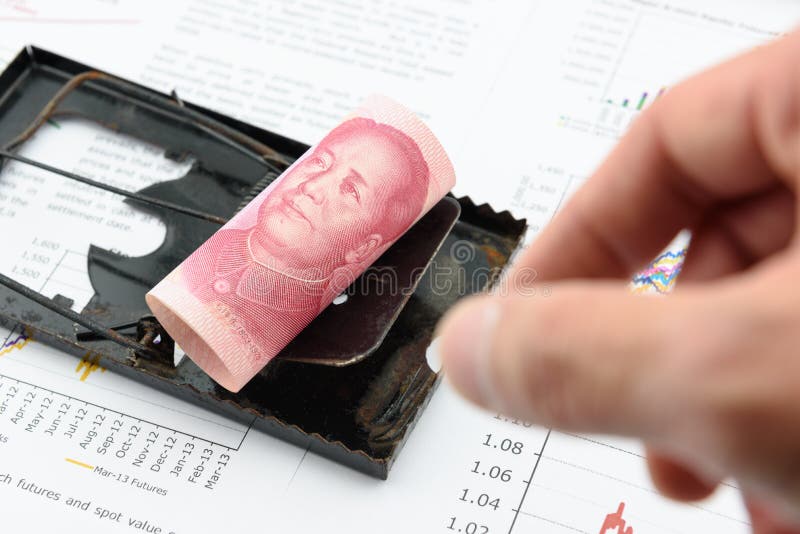 Rolled up scroll of CNY Chinese 100 yuan bill with portrait / image of Mao Zedong on a black rat trap. Using money as a bait to lure someone for illegal / dishonest things. China financial concept.