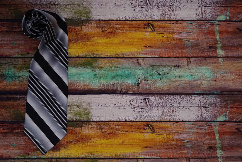 Rolled Up Tie on Wooden Floor Stock Photo - Image of colorful, card ...
