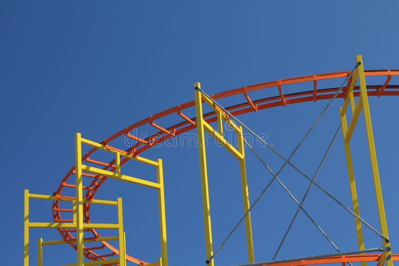 A roller coaster at a seaside resort seen with a crisp blue sky background. Boardwalk rail stock images, royalty-free photos and pictures
