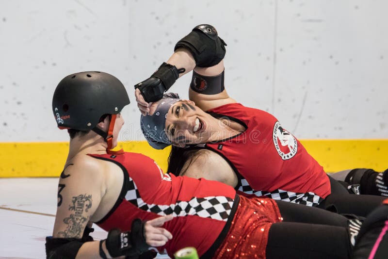 Redding, California: Two skaters from the Red Bluff Derby girls team stretch out on the track before a bout against Shasta Roller Derby. Redding, California: Two skaters from the Red Bluff Derby girls team stretch out on the track before a bout against Shasta Roller Derby.