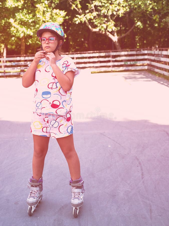 Roller skating girl in park rollerblading on inline skates. Caucasian girl in outdoor activities royalty free stock photo Roller skating girl in park rollerblading on inline skates. Caucasian girl in outdoor activities royalty free stock photo