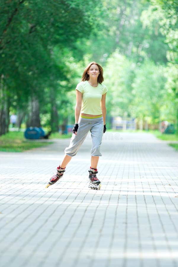 Roller Skating Sporty Girl in Park Rollerblading on Inline Skate Stock