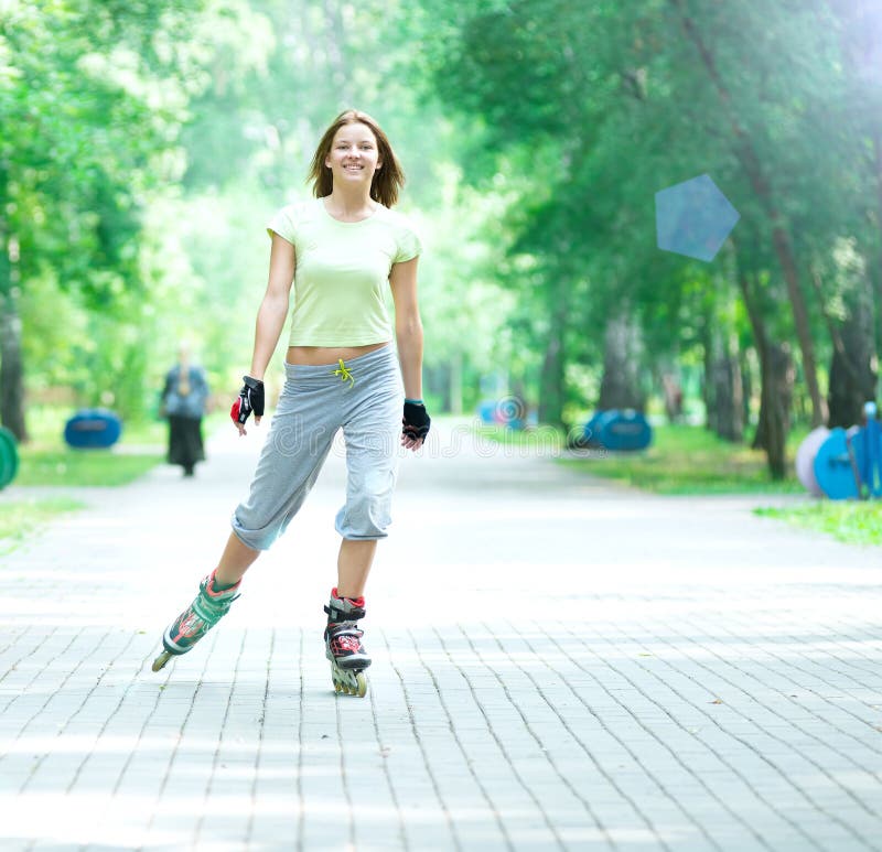 Roller Skating Sporty Girl in Park Rollerblading on Inline Skate Stock