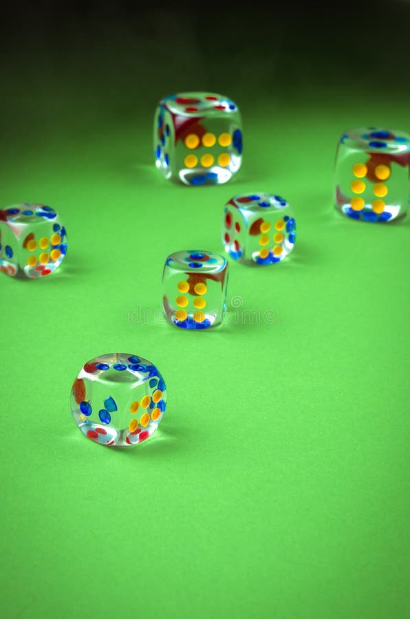 Rolling Casino Dice/Rolling Casino Dice on a Green Background Stock