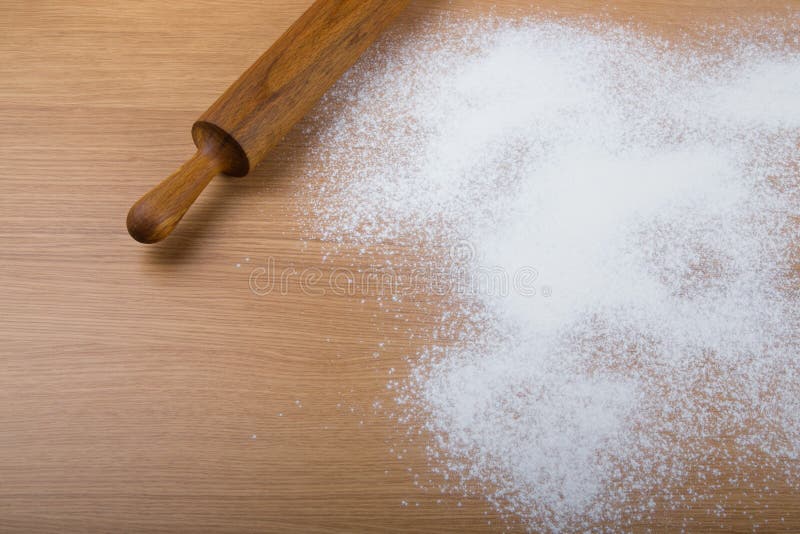 Rolling pin and flour sprinkled on a light wooden table royalty free stock images Rolling pin and flour sprinkled on a light wooden table royalty free stock images