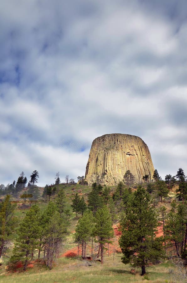 Devil&#x27;s Tower is America&#x27;s first National Monument. Here is a shot of this unique land formation with rolling clouds above it. Devil&#x27;s Tower is America&#x27;s first National Monument. Here is a shot of this unique land formation with rolling clouds above it.