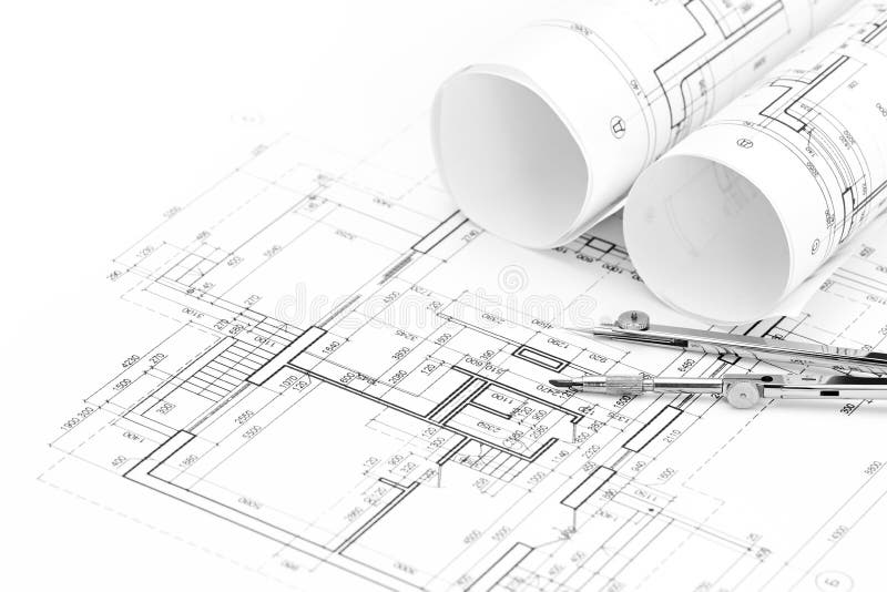 Rolls of architectural blueprints and floor plan with drawing compass stock photos