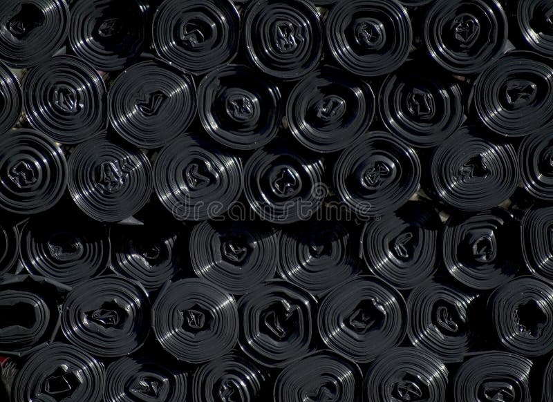 Rolls of black plastic sacks royalty free stock photography