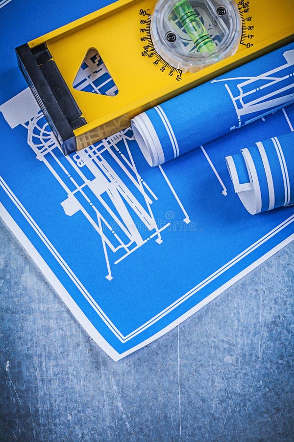 Rolls of blue engineering drawings level on metallic background stock image Rolls of blue engineering drawings level on metallic background stock image