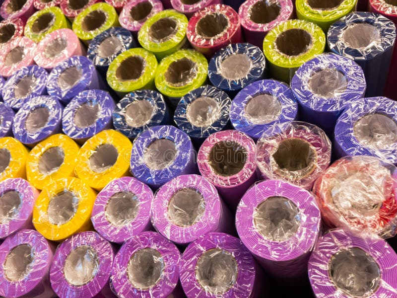 Rolls of decorative wrapping paper of different colors are on the store shelf stock images