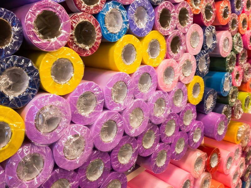 Rolls of decorative wrapping paper of different colors are on the store shelf stock image